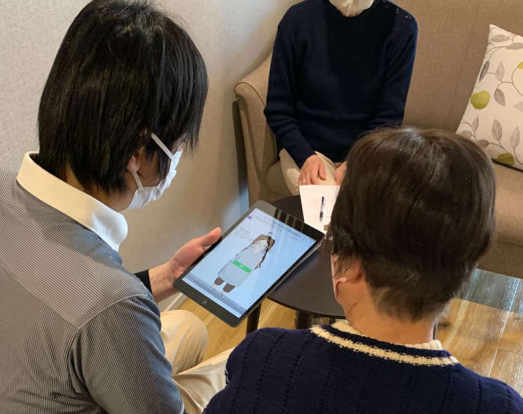 Elderly woman and staff are interacting with the AI avatar