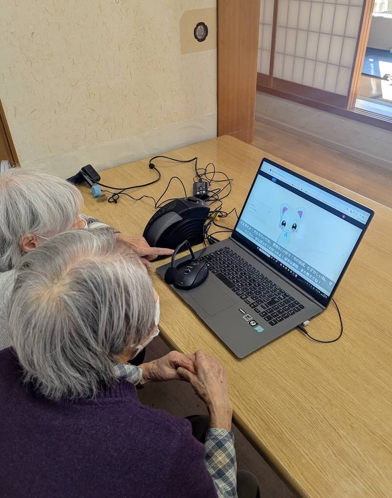 Residents at Yutaka Day Service engaging with the AI companion