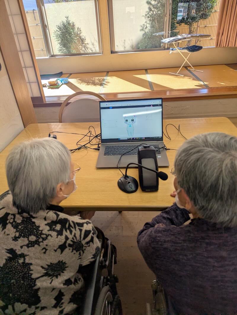 Residents at Yutaka Day Service engaging with the AI companion