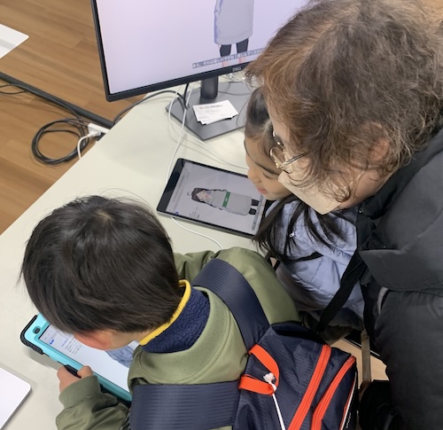 children and their grandma interacting with conversational avatars on iPads